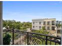 Enjoy the neighborhood view from the balcony with wrought-iron railings, providing a charming outdoor space at 525 N Orange Ave # 302, Sarasota, FL 34236