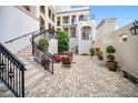 Charming courtyard with brick pavers, wrought iron accents, and outdoor seating creates a tranquil space at 525 N Orange Ave # 302, Sarasota, FL 34236