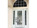 Elegant front door with decorative glass and sidelights, enhancing the home's entry at 5981 Willows Bridge Loop, Ellenton, FL 34222