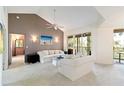 Bright living room featuring vaulted ceilings, neutral walls, and access to outdoor balcony at 6101 34Th W St # 11C, Bradenton, FL 34210