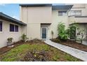 Clean exterior with neutral colors, simple landscaping, and defined walkway leading to the entrance at 6860 Whitman Ct # 32B, Sarasota, FL 34243