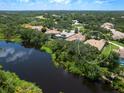 Aerial view showing home's location on pond, in a neighborhood with mature tree coverage at 7003 Lancaster Ct, University Park, FL 34201