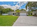 Inviting single-story home featuring a well-maintained lawn and a spacious driveway leading to a garage at 8007 17Th Nw Ave, Bradenton, FL 34209