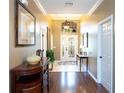 Inviting foyer with hardwood floors, high ceilings, and decorative chandelier at 8078 Stirling Falls Cir, Sarasota, FL 34243
