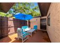 Charming outdoor patio featuring comfortable seating under an umbrella for relaxation and entertaining friends at 8472 60Th N St # 702, Pinellas Park, FL 33781