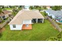 Aerial view of a home showcasing a spacious backyard with a screened porch and wooden deck at 9402 71St E Ave, Palmetto, FL 34221