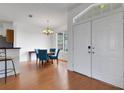 Open-concept dining area with hardwood floors, a chandelier, and plenty of natural light at 9402 71St E Ave, Palmetto, FL 34221