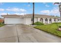 A well-maintained single-story home with a driveway and a manicured front lawn at 107 Van Dyck Dr, Nokomis, FL 34275