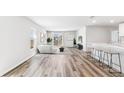 Bright living room with wood floors, modern furnishings, and sliding door to a waterfront view at 12064 Lansing Gln, Parrish, FL 34219