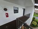 Exterior of condo featuring unit number, stairway, and nearby landscaping at 1211 Capri Isles Blvd # 116, Venice, FL 34292