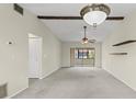 Spacious living room featuring vaulted ceilings, carpet flooring, and sliding glass doors at 1227 56Th St W # 1227, Bradenton, FL 34209