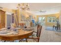 Inviting dining room showcasing a round table setting, decorative artwork, and a bright, airy atmosphere with natural light at 1250 N Portofino Dr # 208, Sarasota, FL 34242