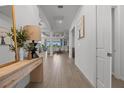 Bright and airy foyer with wood-look tile flooring, leading into the home's open layout at 17632 Santorini Ct, Venice, FL 34293