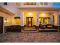 Inviting front porch with seating area, stylish planters and modern lighting at 1954 Goldenrod St, Sarasota, FL 34239