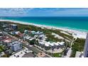 Aerial view of a beachfront condo community with a swimming pool and stunning ocean views at 222 Beach Rd # 7, Sarasota, FL 34242