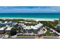 Beachfront condo exterior showcasing modern architecture and lush landscaping with palm trees at 222 Beach Rd # 7, Sarasota, FL 34242
