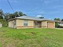 A single-story home with a well-kept lawn, with chain link fencing in the background at 2403 Trianna St, North Port, FL 34291