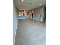 Open-concept living area with tile flooring that seamlessly connects to the kitchen at 24827 Buckingham Way, Port Charlotte, FL 33980