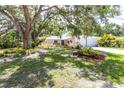 Well-kept one-story home with a two-car garage and shaded by mature trees at 2515 Huntington Ave, Sarasota, FL 34232