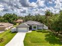 Lovely aerial shot of a bright home with nice landscaping, a grey roof and a manicured front yard at 2546 Malibu Ln, North Port, FL 34286