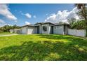 Stylish single-story home featuring a freshly mowed lawn, a two-car garage, and modern landscaping at 2546 Malibu Ln, North Port, FL 34286