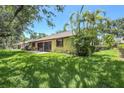 Expansive backyard featuring well-manicured lawn, screened lanai, and lush landscaping at 3311 39Th W Pl, Bradenton, FL 34205