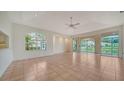 Bright living room with tile flooring, a ceiling fan, and large windows with a view of the water at 3317 Highlands Bridge Rd # 61, Sarasota, FL 34235