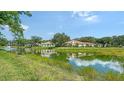 Scenic view of a pond with fountain and lush landscaping, reflecting the nearby homes at 3317 Highlands Bridge Rd # 61, Sarasota, FL 34235