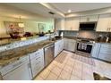Modern kitchen features granite counters, stainless steel appliances, and an open layout to the dining area at 3500 El Conquistador Pkwy # 347, Bradenton, FL 34210