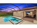 Inviting backyard with a screened-in pool and spa, plus an outdoor seating and dining area at 3504 Big Sky Way, Bradenton, FL 34211