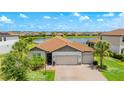 Charming single-story home with a three-car garage, lush landscaping, and a brick-paved driveway at 3504 Big Sky Way, Bradenton, FL 34211