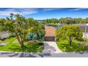Beautiful waterfront property featuring lush landscaping, mature trees, and screened-in lanai with stunning views at 4120 51St W Dr, Bradenton, FL 34210