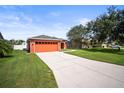 Brightly painted house with 2 car garage and a long driveway in a well-maintained community at 4194 Banbury Cir, Parrish, FL 34219