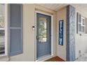 Close-up of the front door with decorative glass, stylish shutters, and a 