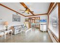 Inviting living room with exposed beams, terrazzo floors, adjacent sitting room, and coastal décor at 4528 58Th W St, Bradenton, FL 34210