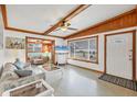 Bright living room with terrazzo floors, exposed wood beams, and a large window with natural light at 4528 58Th W St, Bradenton, FL 34210