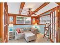 Cozy sitting room featuring wainscoting, exposed beam ceiling, and comfortable seating at 4528 58Th W St, Bradenton, FL 34210