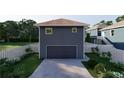 Rear view of the house featuring a two-car garage and a well-maintained, fenced backyard at 4759 11Th S Ave, St Petersburg, FL 33711