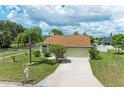 Well-maintained home with a long driveway, lush front lawn, and mature trees, offering great curb appeal at 4811 14Th E Ave, Bradenton, FL 34208