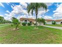 Beautifully landscaped front yard with mature trees, green grass, and a well-maintained lawn at 4811 14Th E Ave, Bradenton, FL 34208