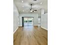 Spacious living room with hardwood floors, ceiling fan and sliding glass doors leading to the lanai at 4811 14Th E Ave, Bradenton, FL 34208