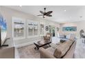 Cozy living room with neutral walls, plantation shutters, a ceiling fan, and comfortable seating for a relaxing atmosphere at 5142 51St W Ln, Bradenton, FL 34210