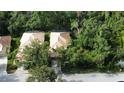 Aerial view showcases the home's roof, screened-in pool, and surrounding greenery at 6744 Hickory Hammock Cir, Bradenton, FL 34202
