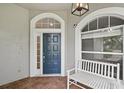 Welcoming front entrance with a stylish door, decorative windows and a cozy bench at 6744 Hickory Hammock Cir, Bradenton, FL 34202