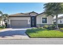 Stunning single-story home boasting a two-car garage, brick driveway, and lush landscaping at 7140 Marsh View Ter, Bradenton, FL 34212