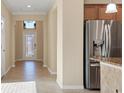 Bright foyer area with decorative glass front door and neutral color palette at 7140 Marsh View Ter, Bradenton, FL 34212