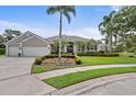 Beautiful single-story home showcases lush landscaping, a spacious driveway, and a convenient two-car garage at 7513 Coventry Ct, Lakewood Ranch, FL 34202
