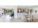 Open-concept dining area featuring white decorative chairs and ample natural light at 837 157Th E Ct, Bradenton, FL 34212