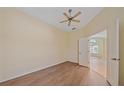 Spacious bedroom featuring wood-look floors, neutral walls, and a large window with shutter blinds at 8382 Creekview Ln, Englewood, FL 34224