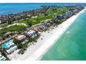 Aerial view of a beachfront property showcasing its proximity to the beach, golf course, and ocean views at 845 Longboat Club Rd, Longboat Key, FL 34228